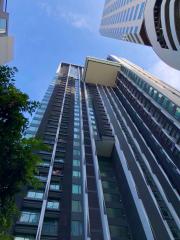 Modern high-rise residential building with clear blue sky