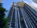 Modern high-rise residential building with clear blue sky