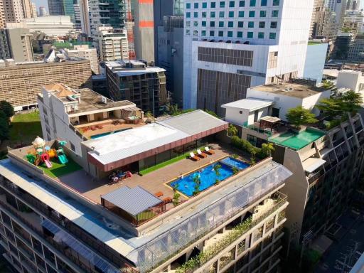 Aerial view of a modern urban building with rooftop amenities