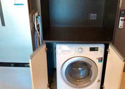 Compact utility area with washing machine and refrigerator