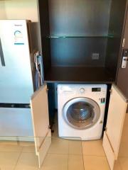 Compact utility area with washing machine and refrigerator