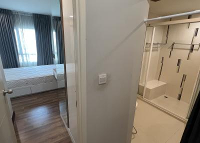 Modern bedroom with built-in wardrobe and laminate flooring