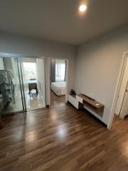 Spacious bedroom with hardwood floors and balcony access