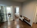 Spacious bedroom with hardwood floors and balcony access