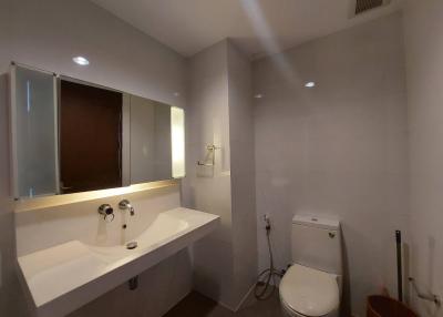Modern bathroom interior with large mirror and white fixtures