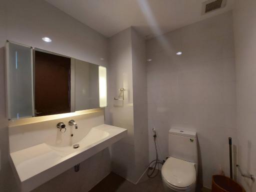 Modern bathroom interior with large mirror and white fixtures