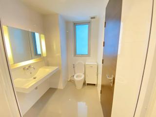 Modern bathroom with white fixtures and a large mirror