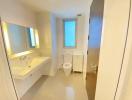 Modern bathroom with white fixtures and a large mirror