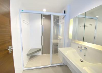 Modern bathroom interior with glass shower and white sink