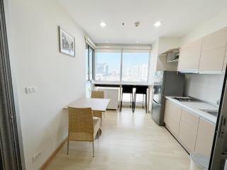 Modern kitchen with dining area and city view