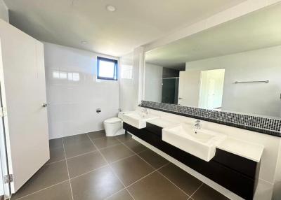 Spacious modern bathroom with double vanity and tiled flooring