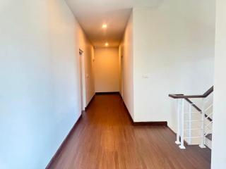 Bright and spacious hallway with wooden flooring