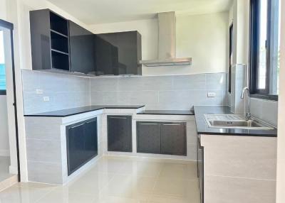 Modern kitchen with stainless steel sink and gray cabinetry