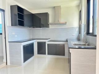 Modern kitchen with stainless steel sink and gray cabinetry