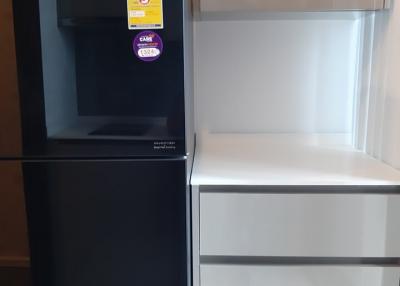 Modern black and white Hitachi refrigerator in a kitchen setting