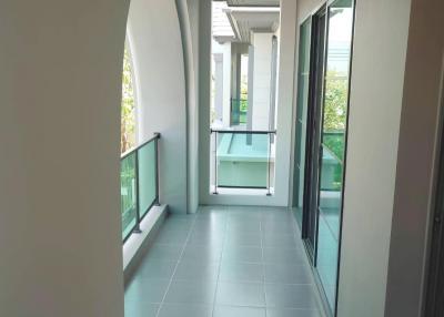 Modern balcony with tiled flooring and glass balustrade