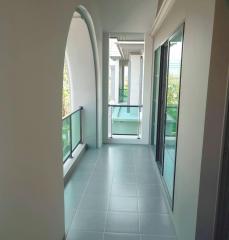 Modern balcony with tiled flooring and glass balustrade