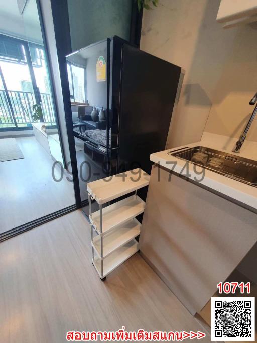 Compact modern kitchen with built-in appliances and access to balcony