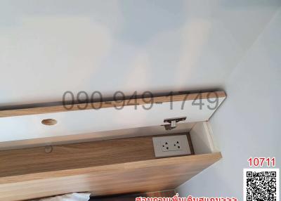 Close-up of a wooden shelf with electrical sockets