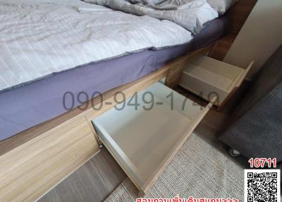 Modern bedroom interior with open drawers in a wooden bed frame