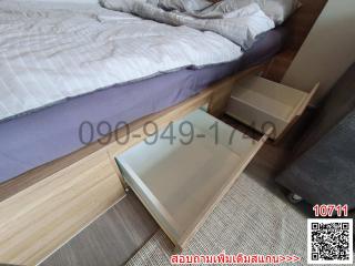 Modern bedroom interior with open drawers in a wooden bed frame