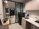 Modern kitchen with glass partition and balcony access