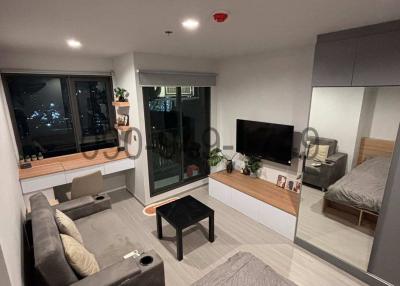 Compact and modern studio apartment interior at night with city view