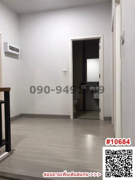 Spacious hallway with tiled flooring leading to a room with air conditioning unit