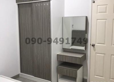 Compact modern bedroom with built-in wardrobe and vanity