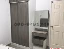 Compact modern bedroom with built-in wardrobe and vanity
