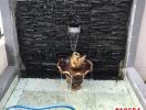 Decorative outdoor water fountain with black tiles