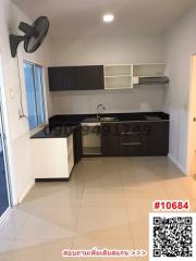 Compact kitchen with white cabinetry and clean design