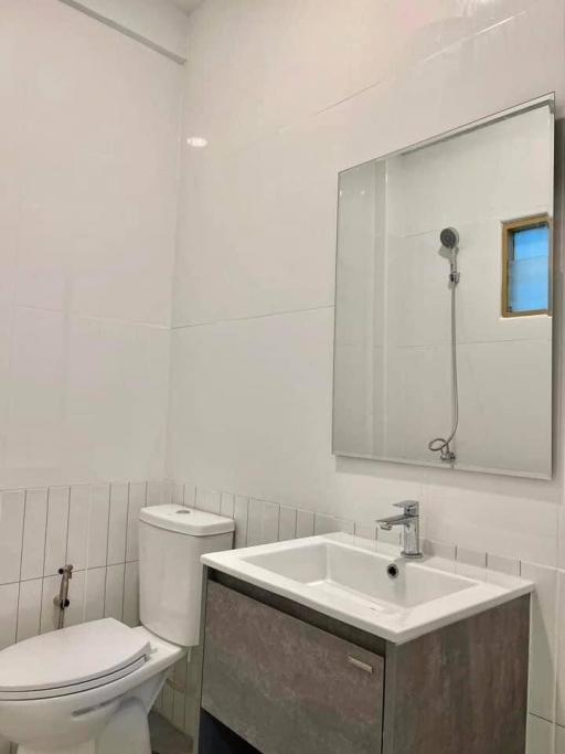Modern bathroom with white fixtures and shower