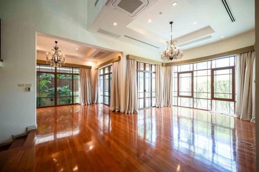 Spacious and bright living room with hardwood floors and large windows