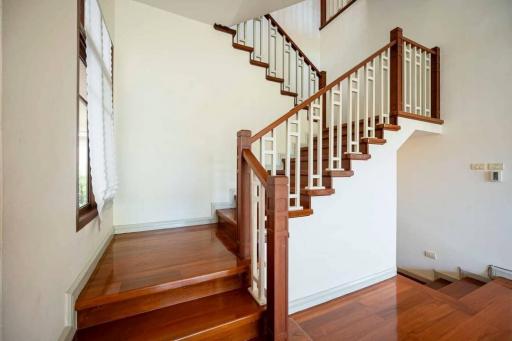 Elegant wooden staircase with handrails in a bright room