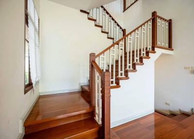 Elegant wooden staircase with handrails in a bright room