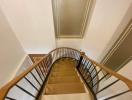 Upward view of a modern staircase with wooden handrails and clean lines