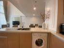 Modern kitchen with integrated appliances and beige cabinetry