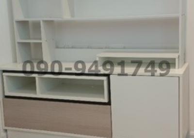 White empty shelving unit in a bedroom with wood flooring