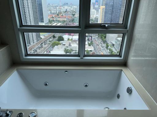 Modern bathroom with large jacuzzi tub and city view through window