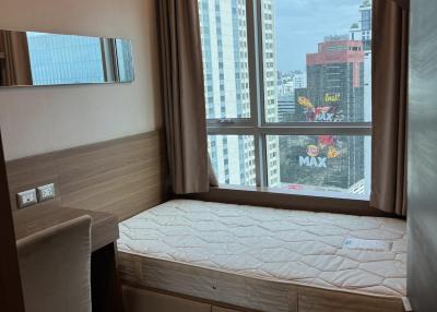 Compact bedroom with natural light and city view
