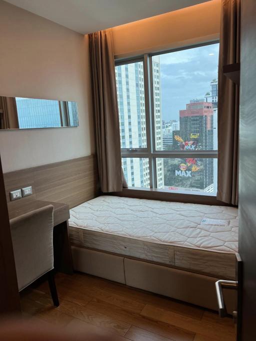 Compact bedroom with natural light and city view