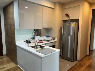 Modern kitchen with stainless steel appliances and wooden flooring