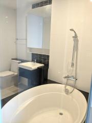 Modern bathroom with a bathtub, sink, and toilet