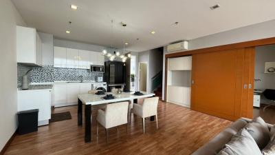 Modern apartment interior with open floor plan including kitchen, dining, and living area