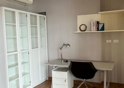 Modern bedroom with home office setup and built-in wardrobe
