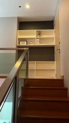 Modern staircase landing with built-in shelving and storage space