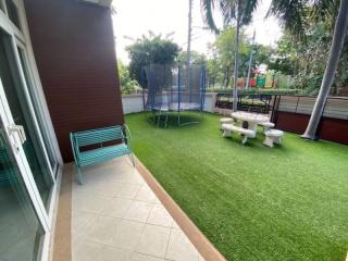Spacious backyard with artificial grass and playground equipment