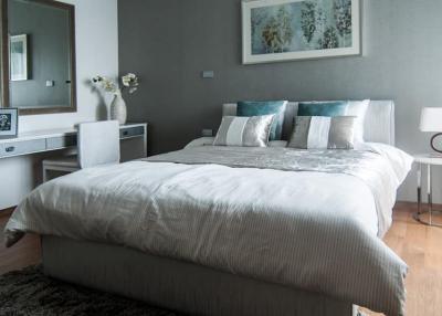 Modern bedroom with neutral color palette and wooden flooring