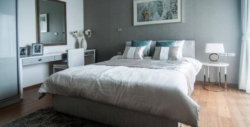 Modern bedroom with neutral color palette and wooden flooring